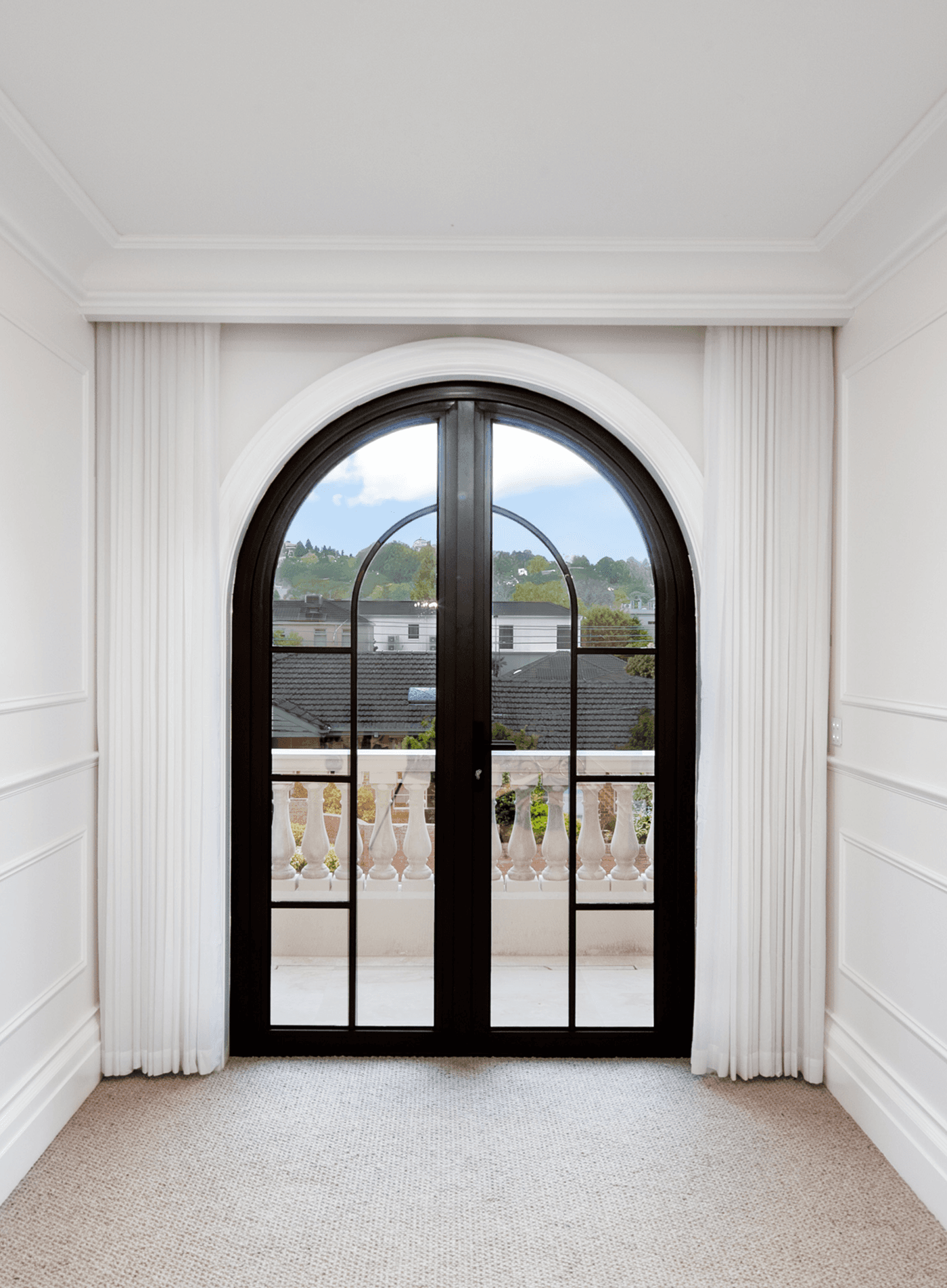 Manoir project — arched French door onto the balcony