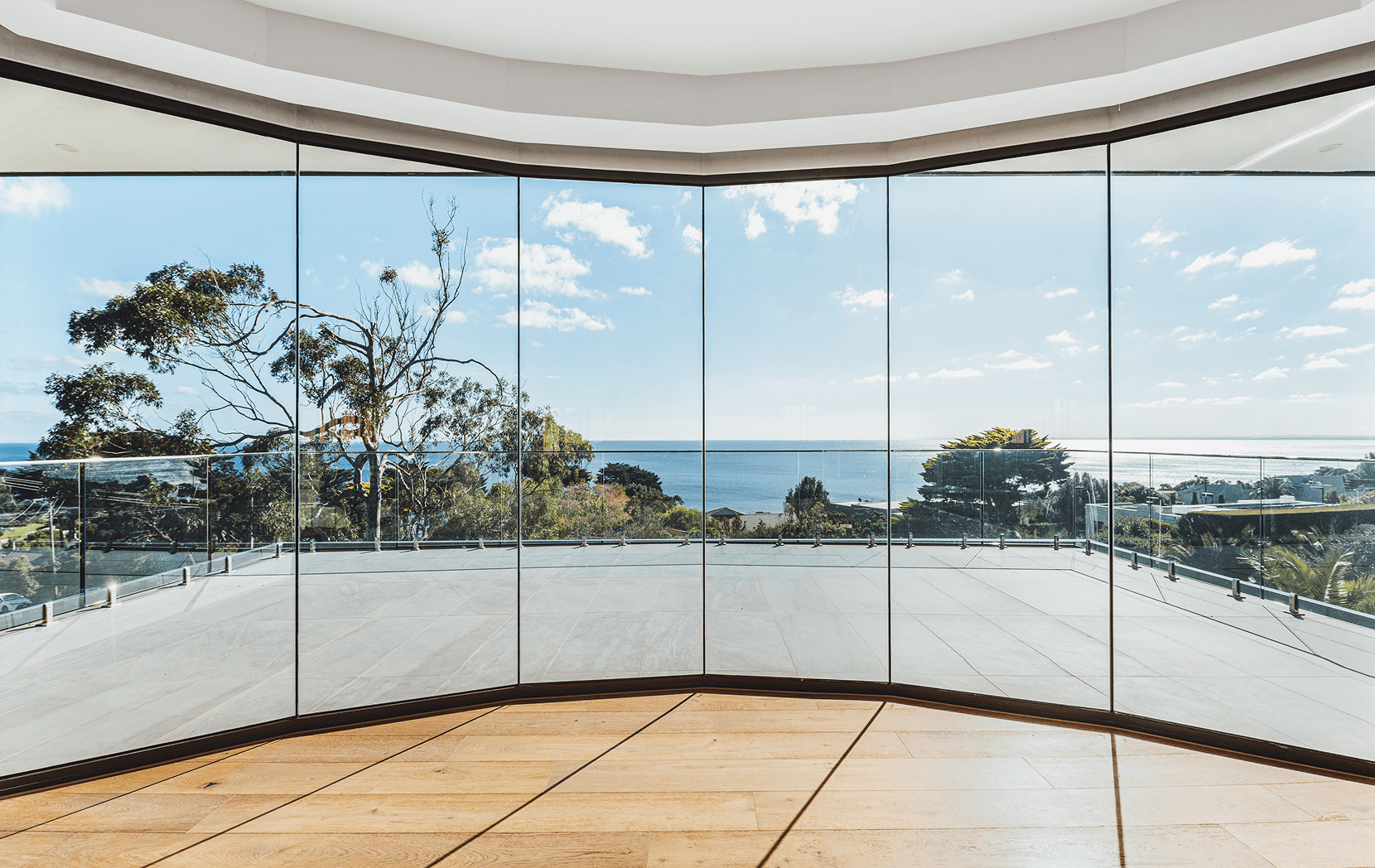 Vue project — curved slim-frame glazing over the bay