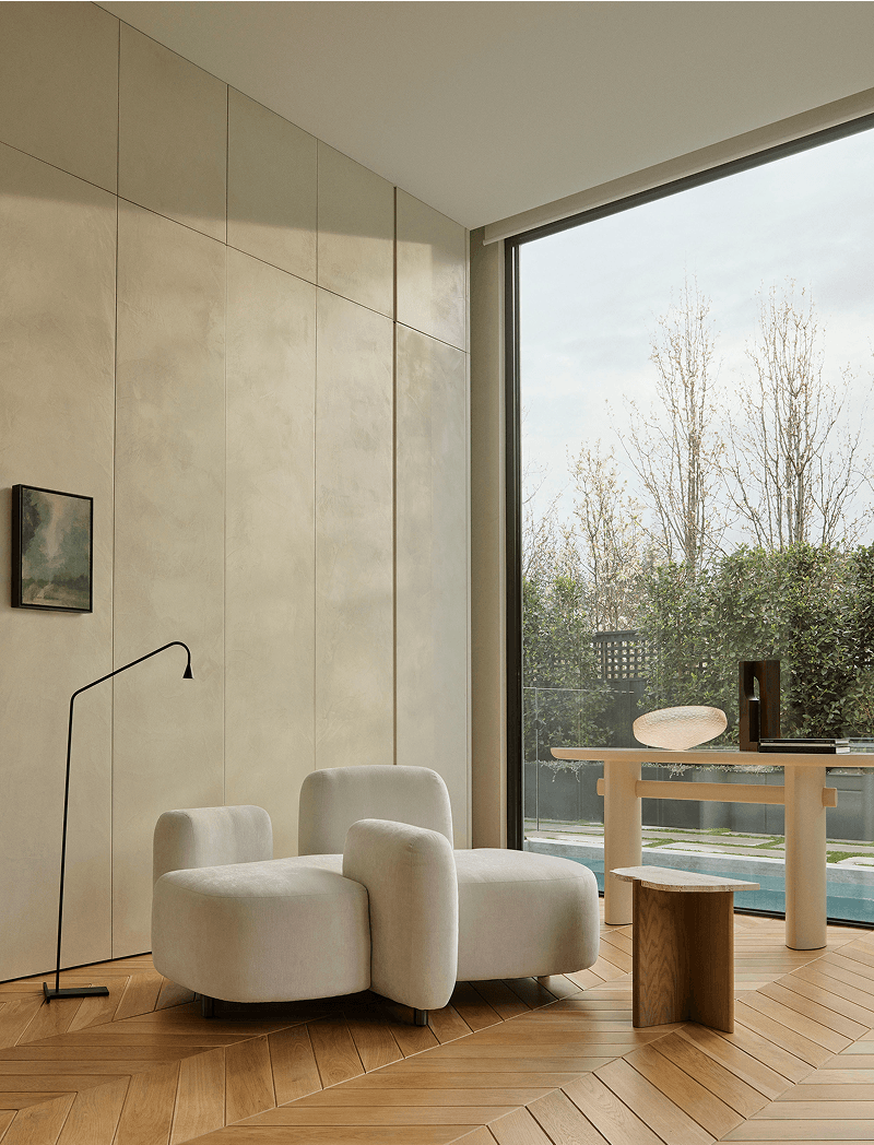 Vue project — boucle chairs beside full-height glazing
